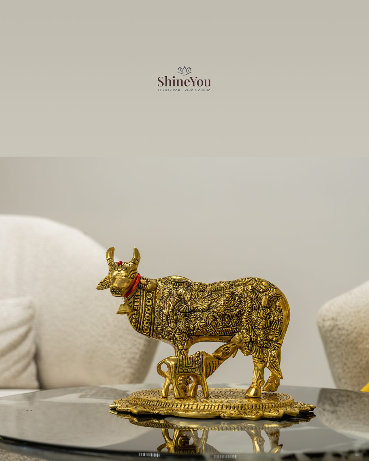 Kamdhenu cow and calf figurine on a marble table