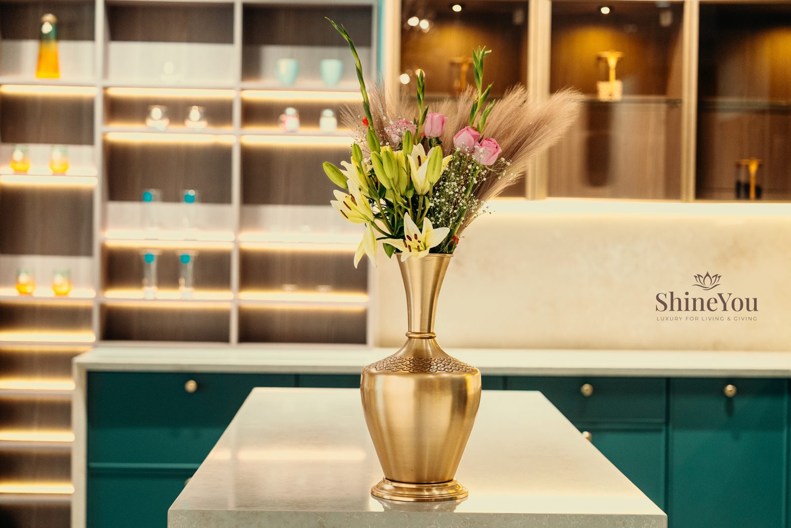 Brass vase with flowers on a kitchen island